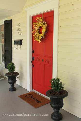 red front door with planters