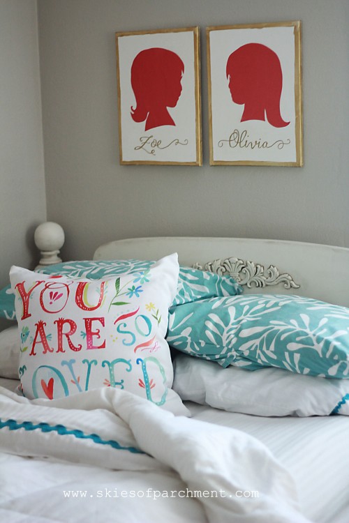 sister silhouettes above the bed