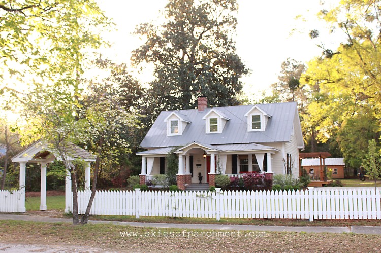 cottage exterior and white picket fence